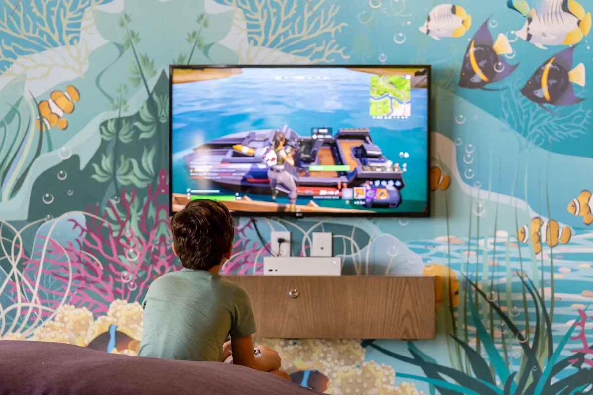 Kid playing video games at Garza Blanca Cancun Kids Club
